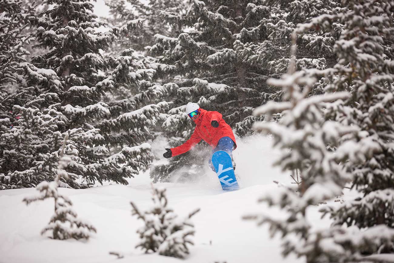 Snow boarder in the trees at Ski Santa Fe.