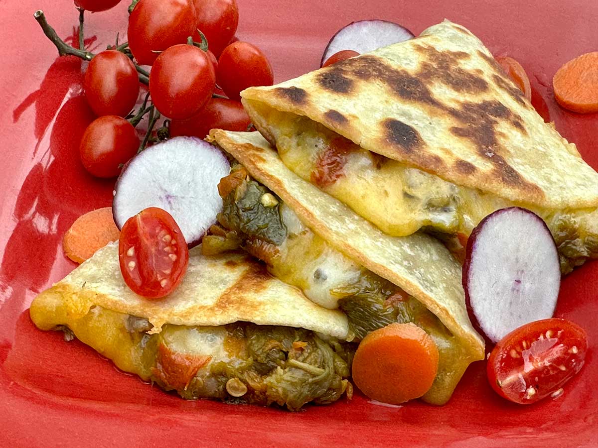 Quesadilla made with a flour tortilla stuffed with green chile, and a blend of Jack & Cheddar cheeses.