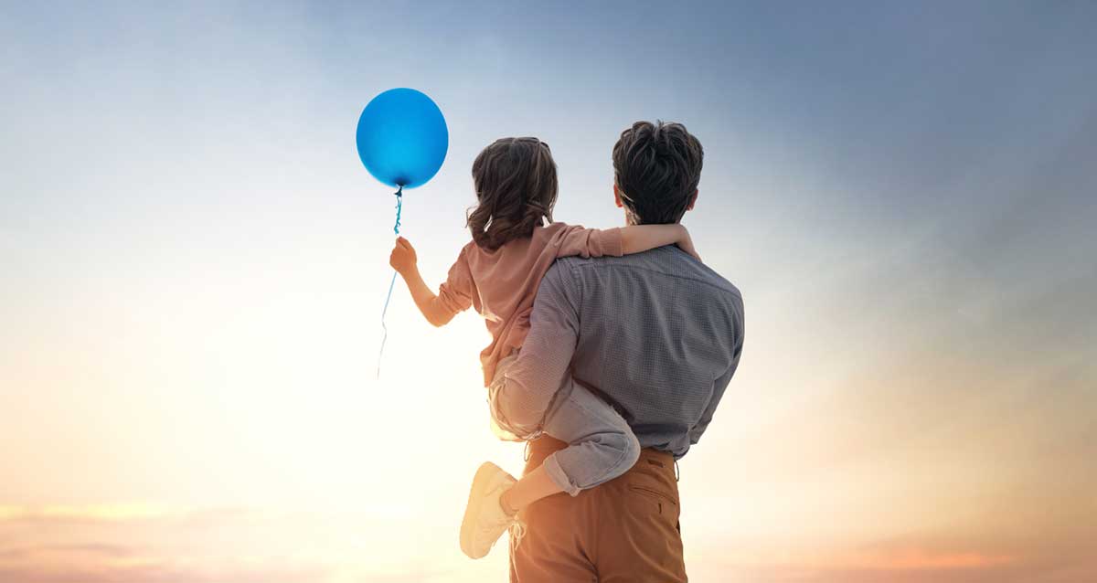 Dad with daughter and blue balloon - Adobe Stock Image