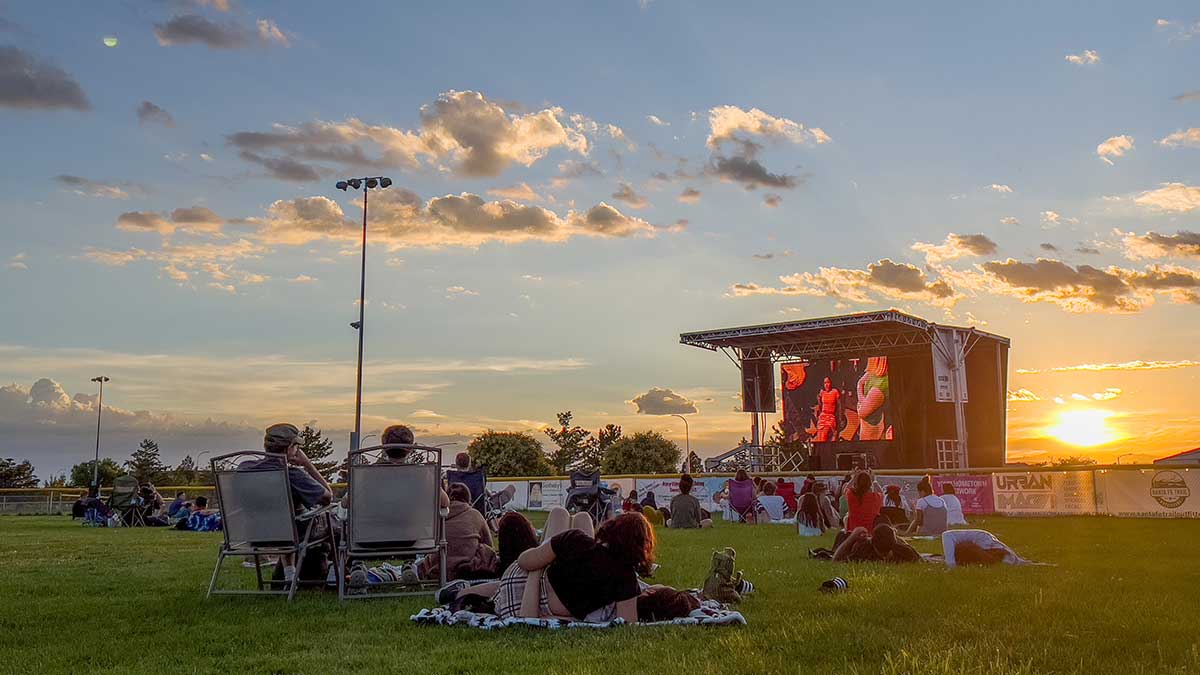 Community engagement with people in park watching movie
