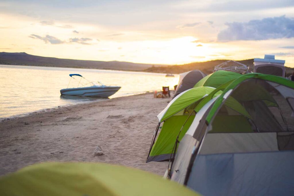 Tents on a lakeside beach at a New Mexico State Park.