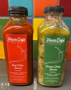 Two bottles of Plaza Cafe chile sauce, red and green