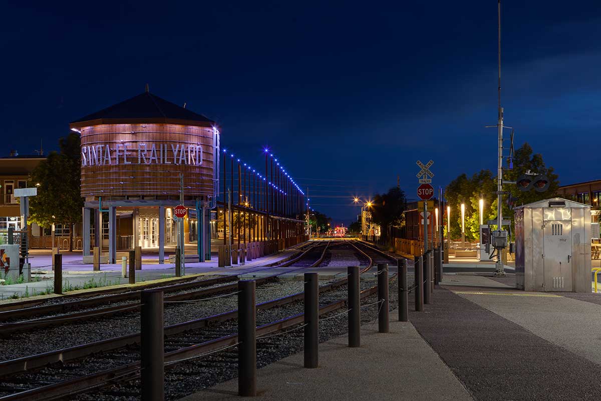 Santa Fe Railyard at dusk with water tower and train tracks.