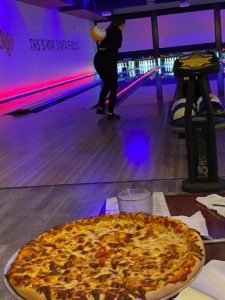 Bowler at The Alley with a pizza in the foreground
