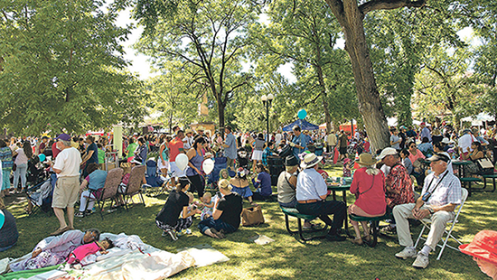 people sitting outside at the Plaza of Santa fe 