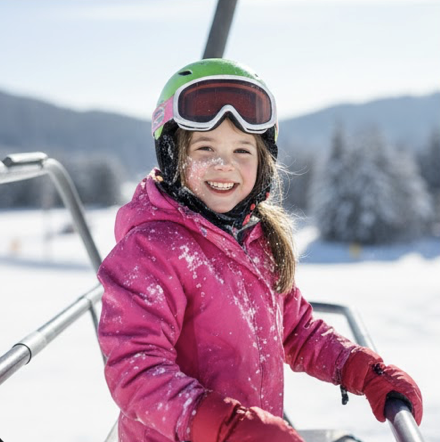 Little girl in pink snowsuit